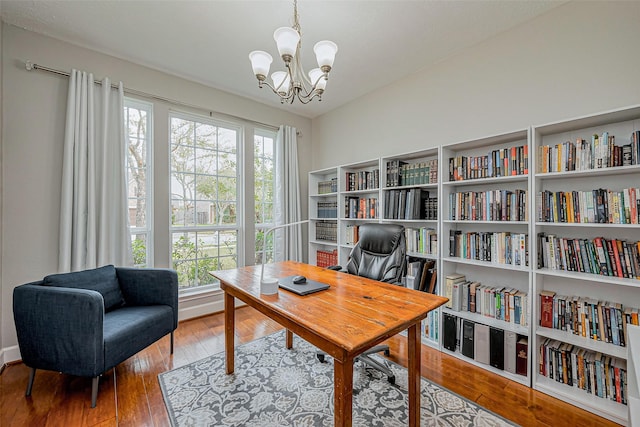 office area with an inviting chandelier and hardwood / wood-style flooring