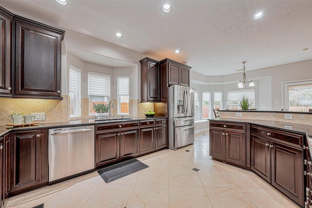 kitchen with tasteful backsplash, dark brown cabinetry, recessed lighting, appliances with stainless steel finishes, and a sink