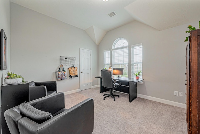 carpeted office featuring lofted ceiling, baseboards, and visible vents