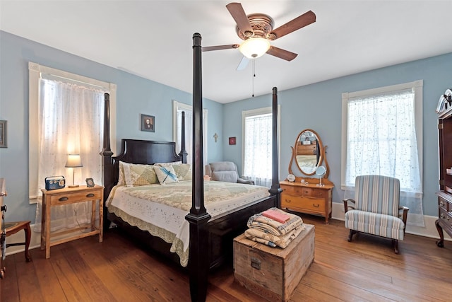 bedroom featuring baseboards, ceiling fan, and hardwood / wood-style floors