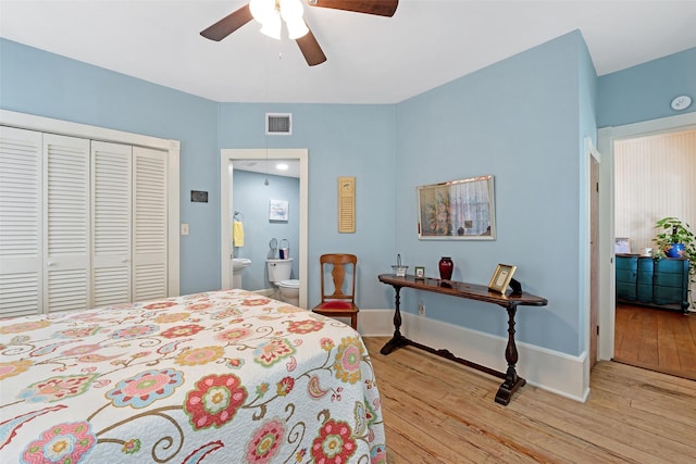 bedroom featuring a closet, visible vents, baseboards, and light wood-style floors