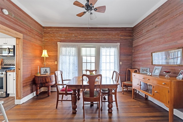 dining area featuring ceiling fan and dark wood-style flooring