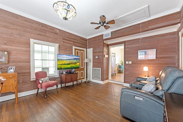 living room featuring visible vents, attic access, a ceiling fan, and hardwood / wood-style flooring