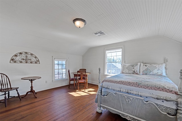 bedroom featuring visible vents, multiple windows, lofted ceiling, and dark wood-style flooring