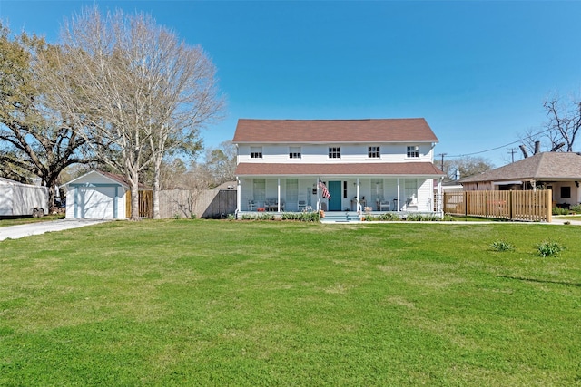 view of front of house featuring a front lawn, a detached garage, a porch, fence, and an outdoor structure