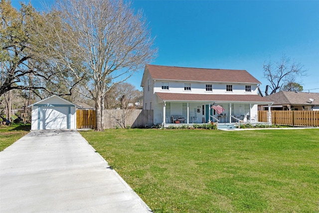 view of front of property with an outbuilding, a front yard, fence, a porch, and a detached garage