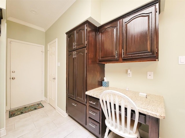 office featuring light tile patterned floors, baseboards, built in desk, and ornamental molding