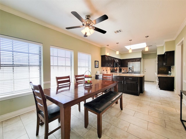 dining space featuring visible vents, a healthy amount of sunlight, baseboards, and ornamental molding