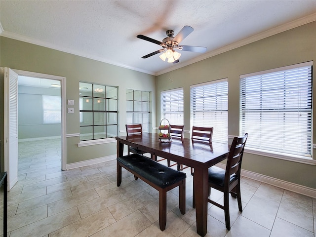 dining room featuring a textured ceiling, a ceiling fan, baseboards, and ornamental molding