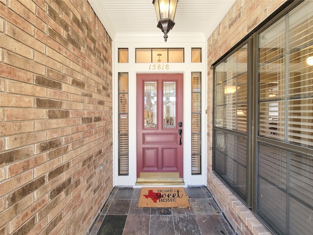 property entrance with brick siding and covered porch