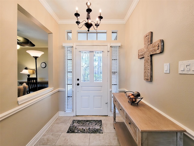 entrance foyer featuring light tile patterned flooring, a chandelier, baseboards, and ornamental molding