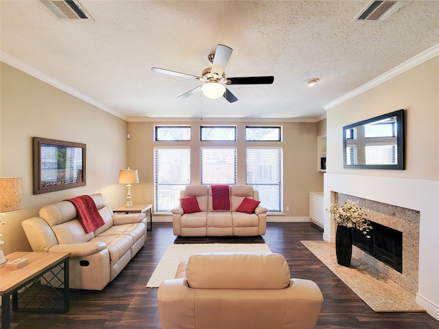 living room featuring dark wood-type flooring, a premium fireplace, visible vents, and ornamental molding