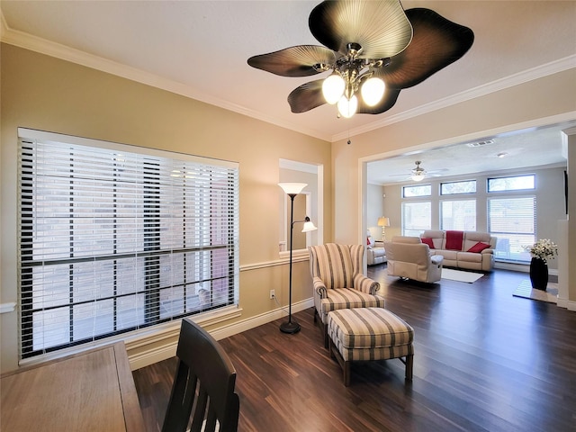 sitting room with dark wood finished floors, ceiling fan, crown molding, and baseboards