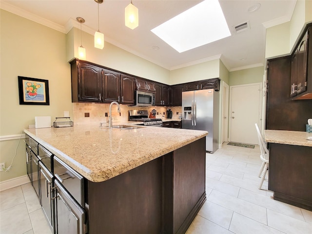 kitchen with visible vents, appliances with stainless steel finishes, a skylight, a peninsula, and a sink