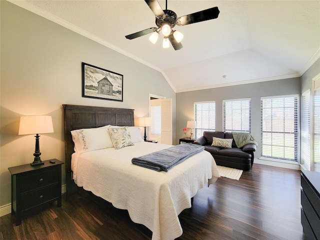 bedroom featuring crown molding, ceiling fan, baseboards, dark wood finished floors, and lofted ceiling