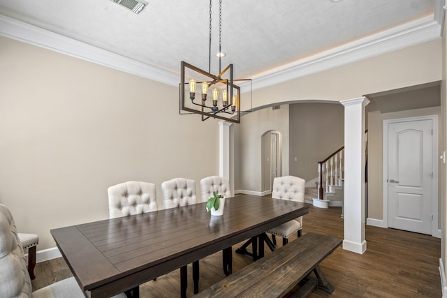 dining room with visible vents, wood finished floors, arched walkways, decorative columns, and baseboards