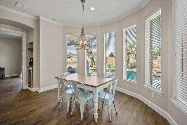 dining room featuring visible vents, baseboards, dark wood-style flooring, crown molding, and a chandelier