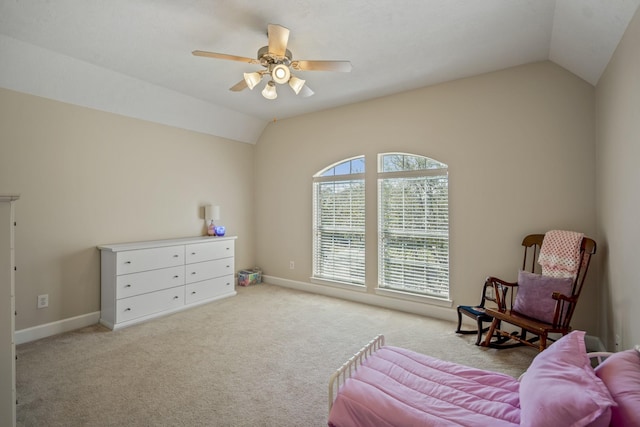 sitting room with baseboards, carpet, ceiling fan, and vaulted ceiling