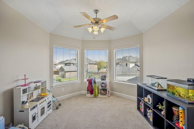 playroom featuring carpet flooring, baseboards, and a ceiling fan