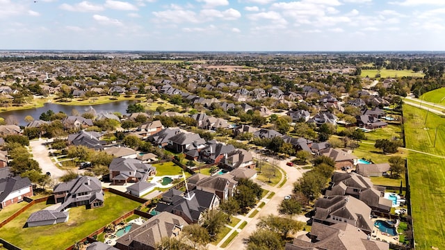 drone / aerial view with a residential view and a water view