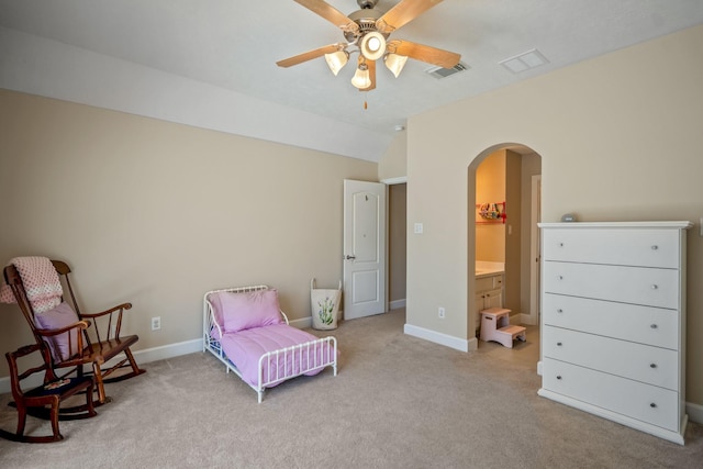 bedroom featuring visible vents, arched walkways, lofted ceiling, and carpet flooring