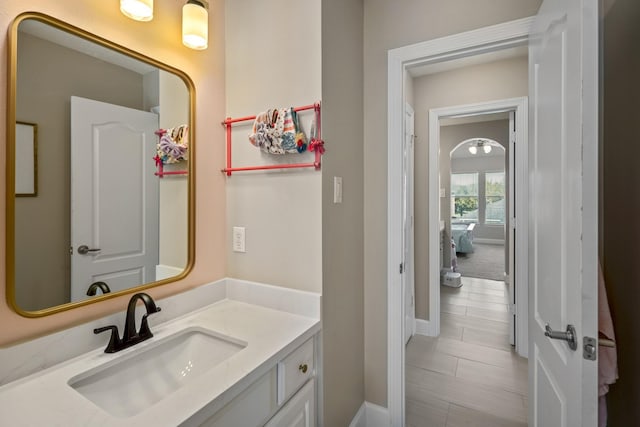 bathroom with baseboards and vanity