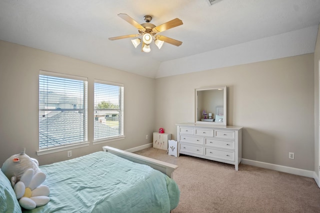 bedroom with lofted ceiling, baseboards, and light carpet