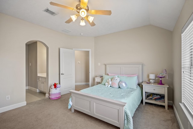 bedroom featuring visible vents, baseboards, arched walkways, vaulted ceiling, and light colored carpet