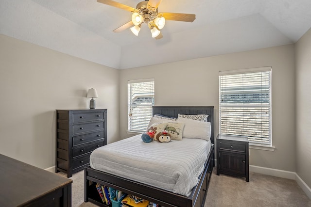 bedroom featuring light carpet, baseboards, lofted ceiling, and a ceiling fan