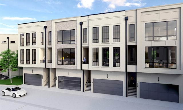 view of front facade with stucco siding and an attached garage