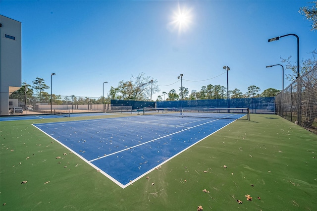 view of tennis court with fence