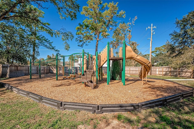 community jungle gym featuring a fenced backyard