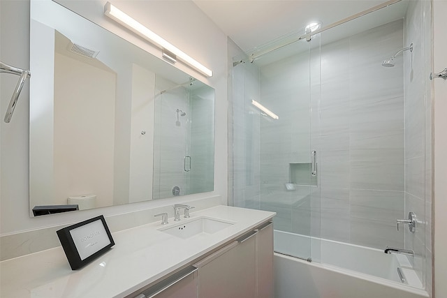 full bath featuring vanity and shower / bath combination with glass door