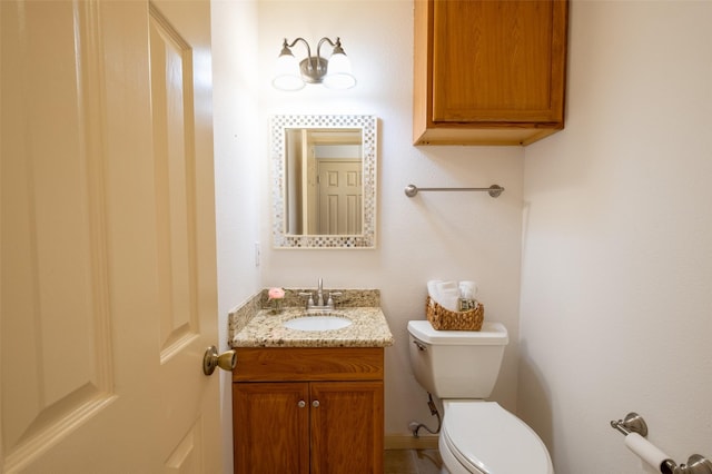 half bath featuring toilet and vanity