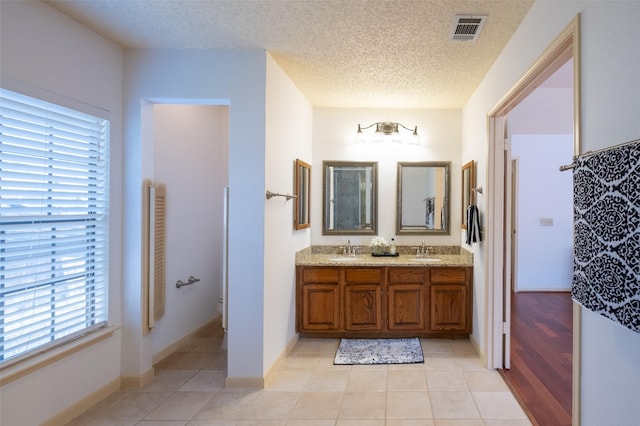 full bathroom featuring a sink, visible vents, and tile patterned floors