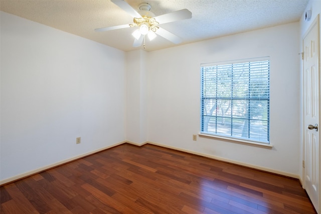 unfurnished room featuring a ceiling fan, wood finished floors, baseboards, and a textured ceiling