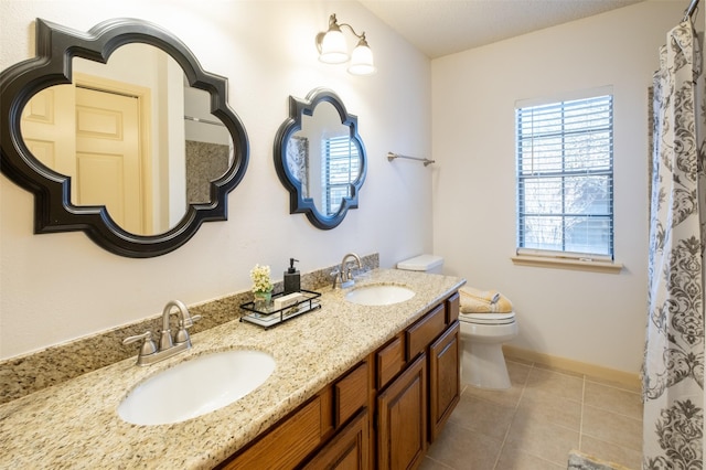 full bathroom with tile patterned flooring, double vanity, toilet, and a sink