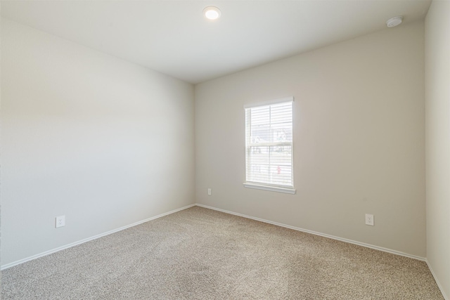 carpeted spare room with baseboards