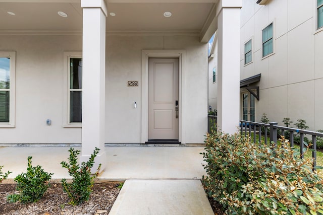 doorway to property featuring stucco siding