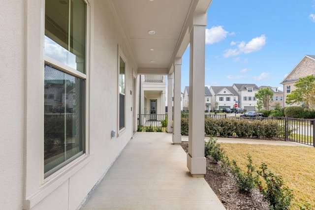 view of patio featuring a residential view and fence