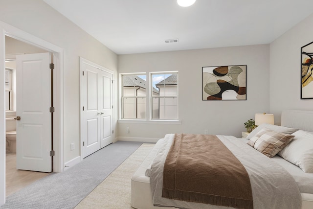 bedroom with carpet, visible vents, and baseboards