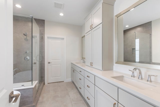 full bath featuring a sink, double vanity, and a shower stall