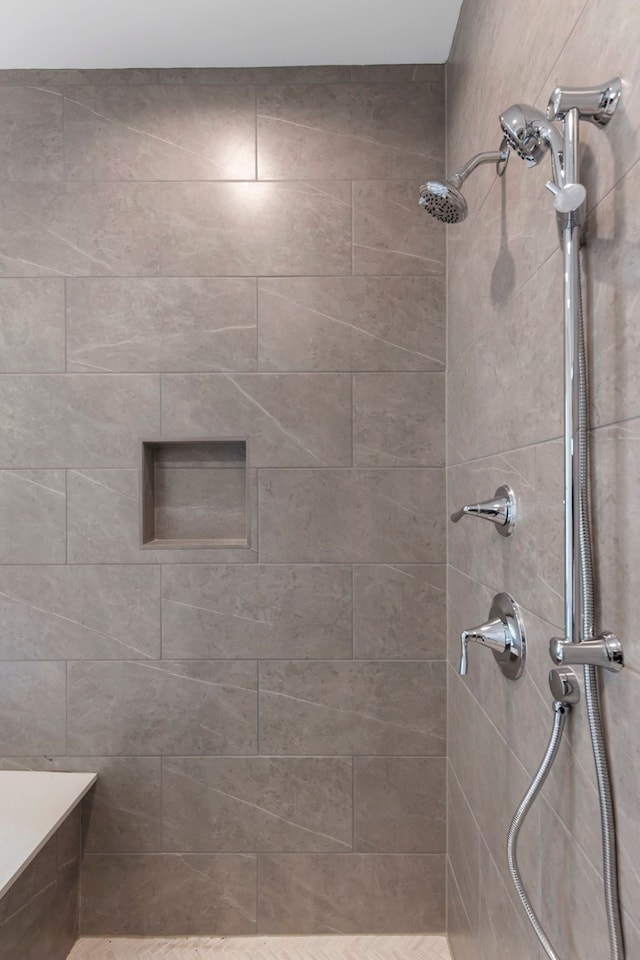 full bath with tiled shower