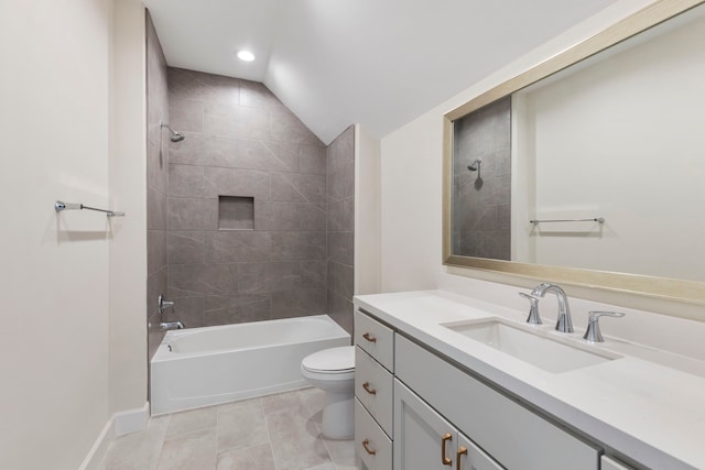 full bathroom featuring baseboards, shower / washtub combination, toilet, lofted ceiling, and vanity