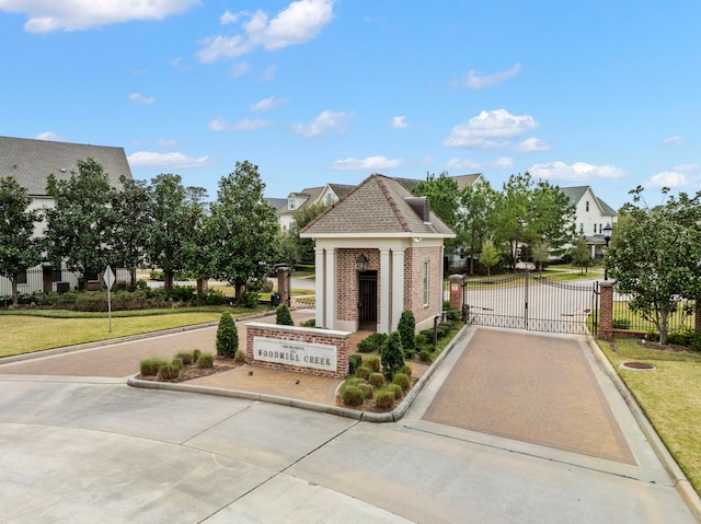 exterior space with a gate, fence, and a yard