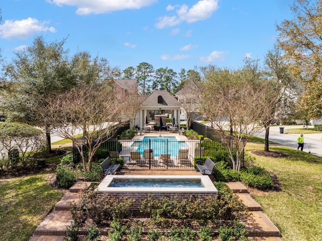 view of pool featuring a fenced in pool, fence, a lawn, a jacuzzi, and a patio