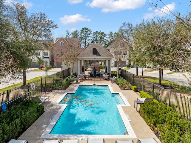 view of swimming pool featuring a gazebo, a patio area, a fenced in pool, and fence