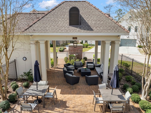 view of patio / terrace featuring a gazebo, a fenced backyard, and an outdoor living space