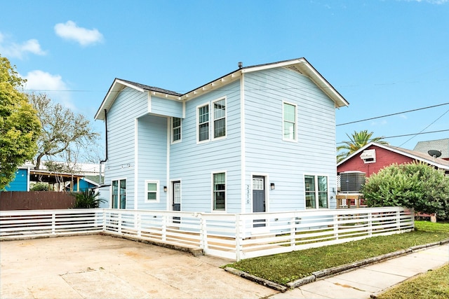 view of front facade featuring fence