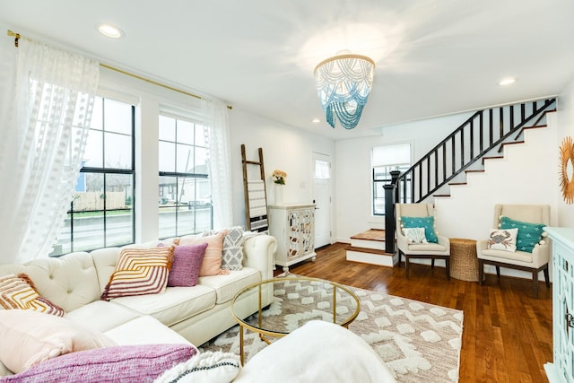 living room featuring recessed lighting, wood finished floors, and stairs